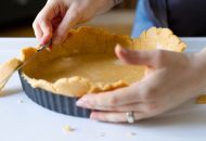
                                  Über die Tarte-Form stehender Teig mit dem Messer abschneiden